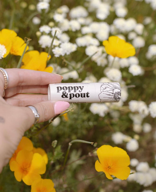 Poppy and Pout all natural lip balm in a field of flowers